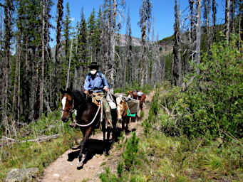 Gary Riding with the Pack String